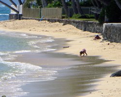 Windward Oahu Scenic Drive: A Girl Plays in the Sand on a Nameless East Shore Oahu Beach